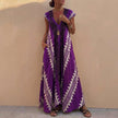 FJØRNA bohemian-inspired purple flowing maxi dress with deep V-neck and geometric motifs, A-line silhouette, lightweight fabric.