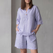 Purple FJØRNA oversized woven two-piece set with a V-neck shirt and high-waist shorts, casual and stylish summer outfit.