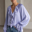 Purple FJØRNA women's summer blouse with V-neck and lace details, stylish sleeveless top for warm weather.