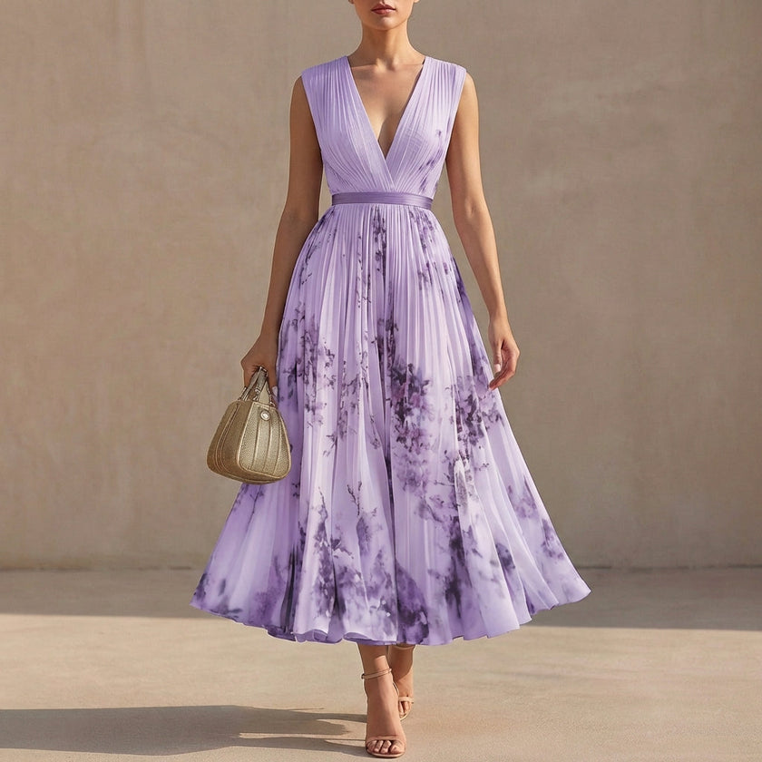 Purple FJØRNA pleated A-line maxi dress with V-neck and balloon sleeves, flowing and elegant on a model.
