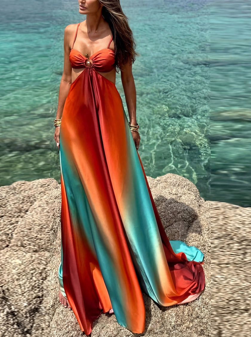Elegant FJØRNA women's maxi dress with cut-out details, perfect for evening wear, featuring flowing fabric and stylish design.