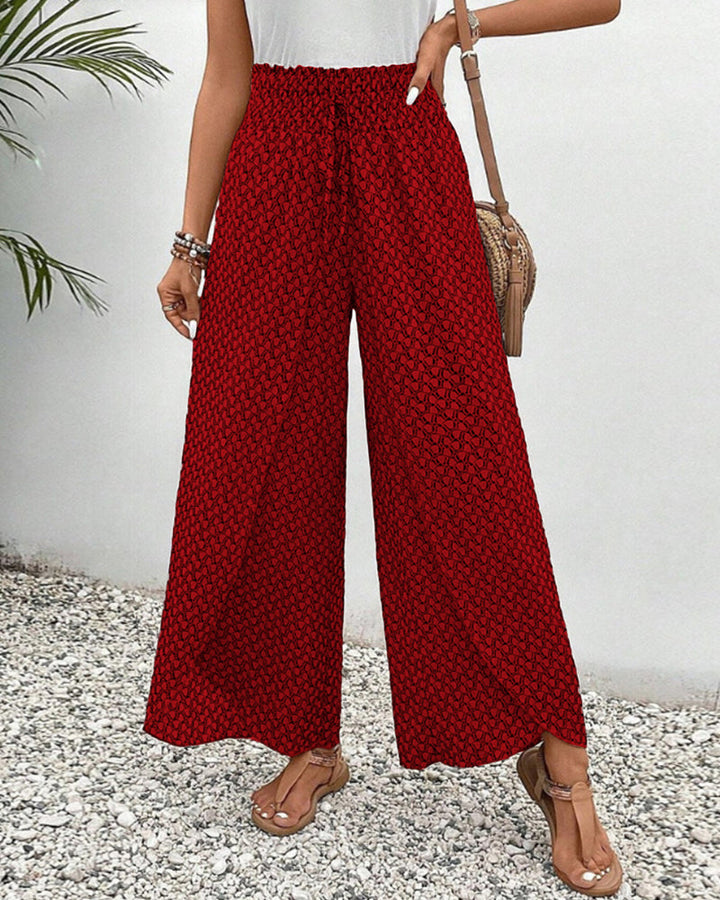 Red FJØRNA lightweight summer women's wide leg trousers, breathable and flowy for warm weather.