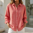 Red striped button-down women's blouse by FJØRNA with cuffed sleeves, casual top perfect for everyday wear.