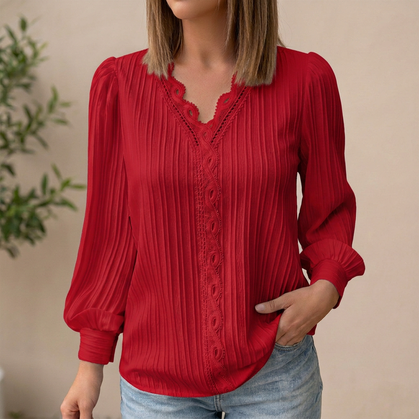 Red women’s pullover blouse by FJØRNA with V-neck, lace trim, and pintuck texture, perfect for casual or dressy occasions.