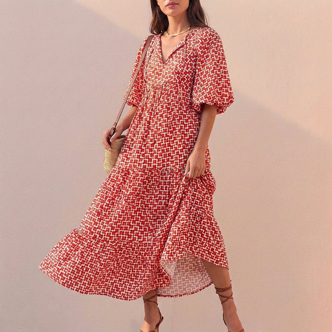 Red women's maxi dress by FJØRNA featuring a V-neckline and puff sleeves, perfect for elegant summer or evening wear.