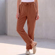 Red linen summer trousers for women with a drawstring waist by FJØRNA, styled for warm weather and casual comfort.