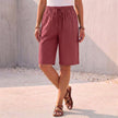 Red women's summer shorts by FJØRNA made of cotton with a drawstring waist, perfect for warm weather.