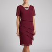 Red FJØRNA flowing tiered mini dress with ruffled sheer sleeves, featuring a lightweight, elegant design perfect for warm weather.
