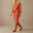 FJØRNA relaxed linen two-piece set with red boat neck blouse and drawstring linen pants, casual and comfortable clothing ensemble.