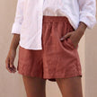 Red women's summer linen shorts with high waist and pockets, relaxed fit by FJØRNA.