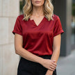 Red FJØRNA summer blouse for women with V-neck, short satin sleeves, casual style, perfect for warm weather.