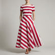 Red FJØRNA A-Line striped maxi dress with pockets for women, featuring a flowing design and bold stripe pattern.