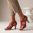 Red FJØRNA orthopedic T-strap heeled sandals for women with ankle straps and block heels, showcasing stylish and supportive footwear.