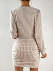 FJØRNA ribbed knit mini dress displayed on a hanger, featuring a fitted silhouette and textured ribbed fabric.
