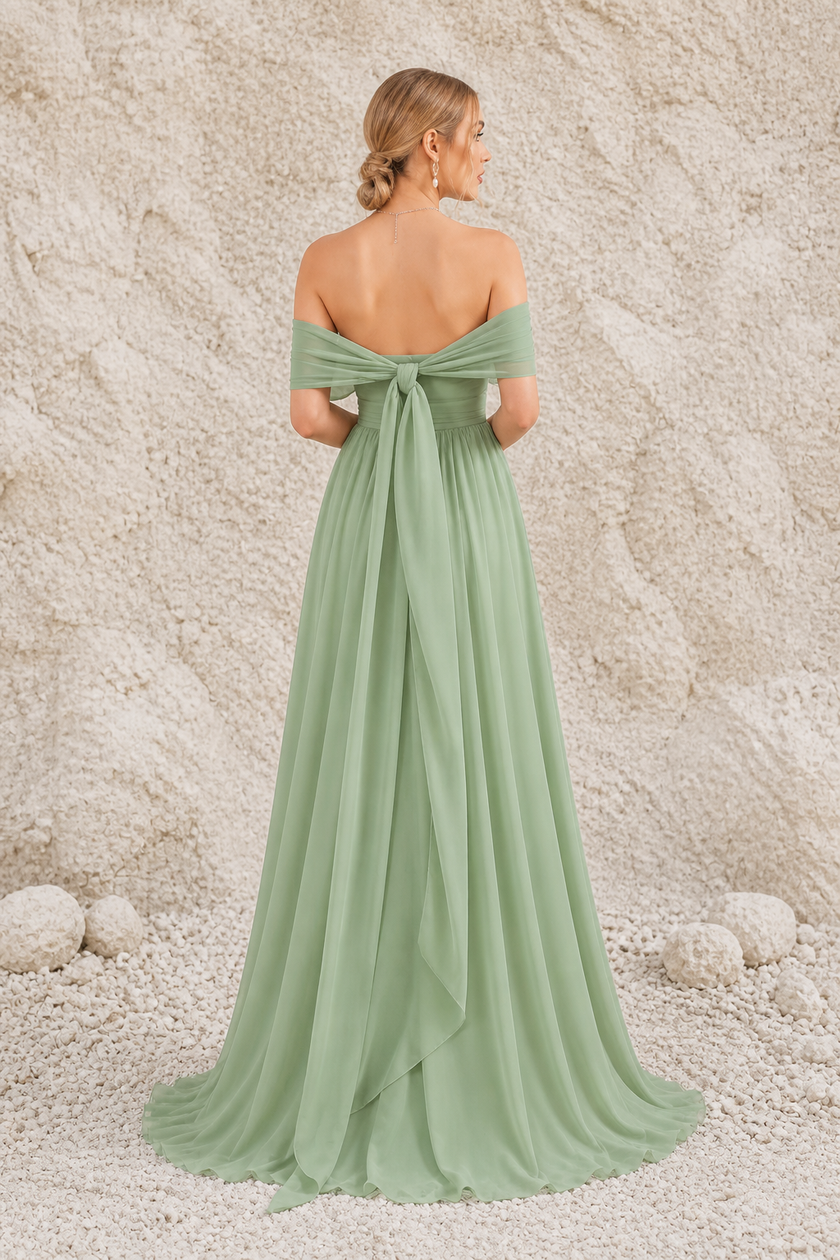 FJØRNA sage green backless dress, sleeveless with a flowing skirt, displayed on a mannequin.