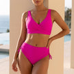 Rose red FJØRNA bikini set with wrap V-neck top and ruched side-tie high-waist bottoms for women, beachwear and swimwear style.