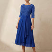 Royal blue embroidered A-line midi dress with sheer sleeves and pockets by FJØRNA, showcasing intricate embroidery and elegant design.