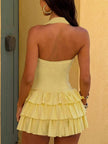 FJØRNA ruffled halter mini dress with layered fabric and sleeveless design, perfect for summer or casual occasions.