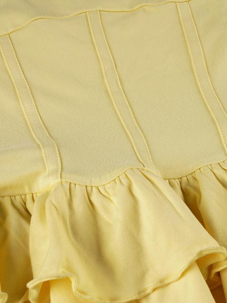 FJØRNA ruffled halter mini dress with a fitted bodice, flowing skirt, and stylish ruffle details, perfect for summer occasions.