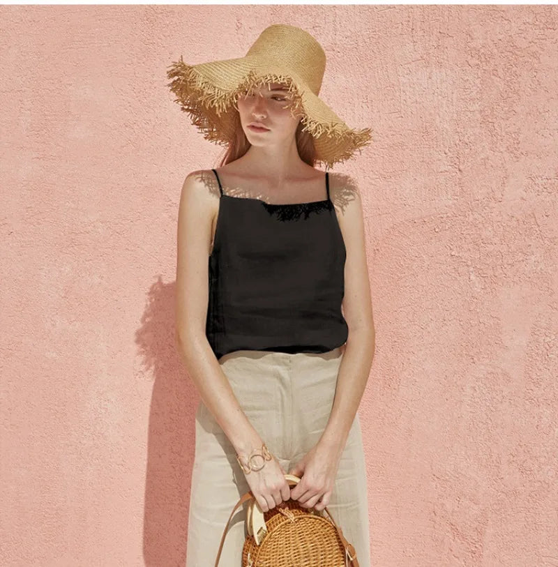 FJØRNA satin-trimmed linen camisole featuring a sleek design and delicate satin accents, laid flat on a neutral background.