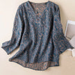 FJØRNA Kaien wrap-style blouse with long sleeves and V-neck, featuring a soft, flowy fabric and tie waist detail.