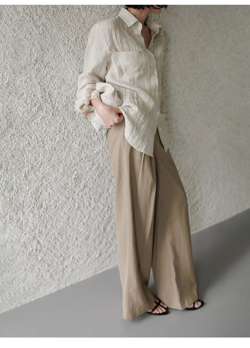 FJØRNA women's linen shirt with pleated design, lightweight and breathable top, shown in a natural, relaxed fit style.