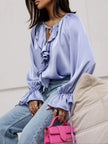 FJØRNA women's satin blouse with ruffle detail, featuring a stylish and elegant top design in smooth satin fabric.