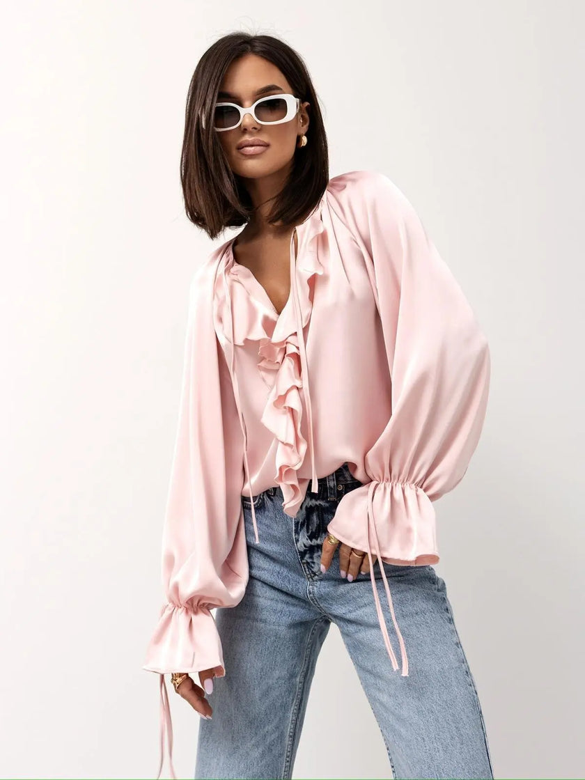 FJØRNA satin women's blouse with ruffle detail, stylish top featuring elegant fabric and feminine design.