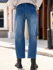 Women’s FJØRNA denim jeans with a classic barrel leg style, showcasing a casual fit and durable denim fabric.
