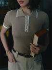 FJØRNA women's cotton polo top featuring a classic collar and short sleeves, styled on a model.