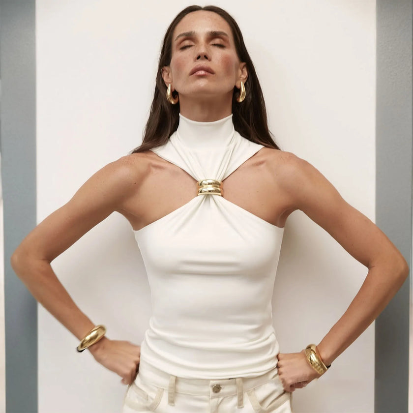 Silk halter neck top for women by FJØRNA, elegant sleeveless blouse with smooth fabric and stylish neckline.