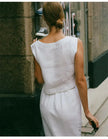 FJØRNA women's linen crop top with short sleeves, lightweight and breathable, shown in a natural beige color.
