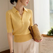 FJØRNA ribbed knit polo blouse for women, featuring a fitted design with a classic collar and long sleeves.