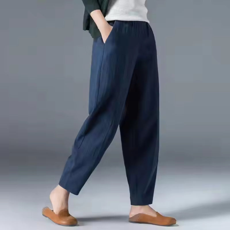 FJØRNA Desiree™ lightweight summer trousers shown in beige, with a relaxed fit and breathable fabric for warm weather.