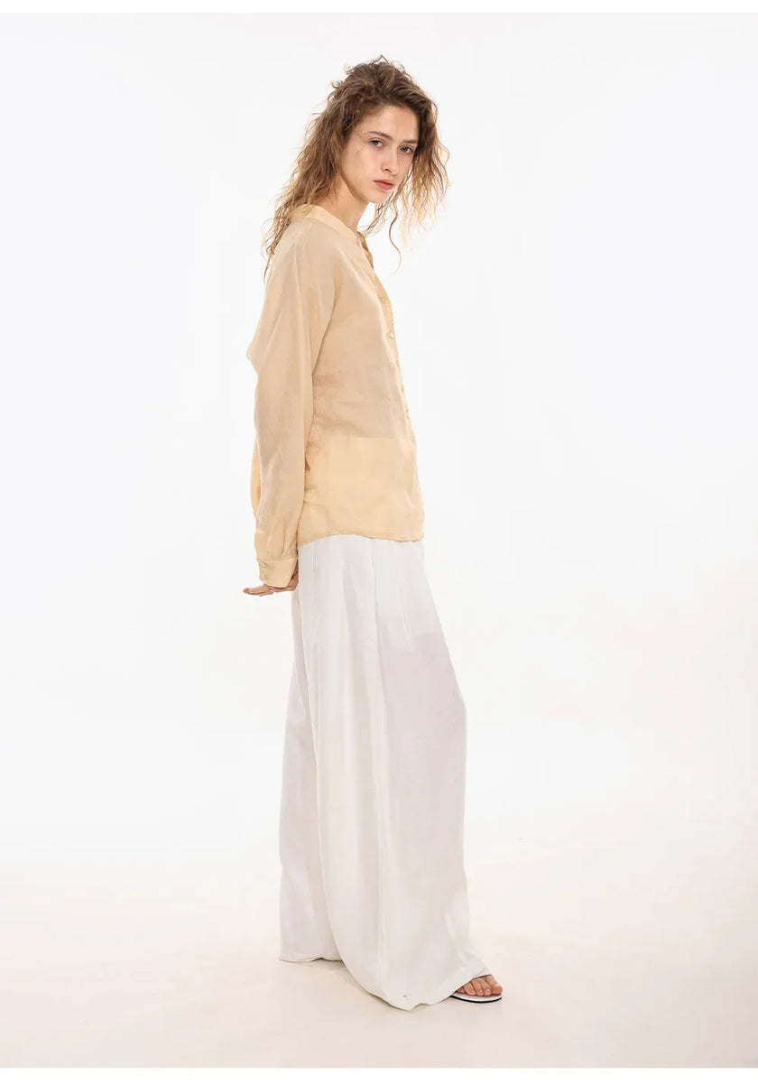 FJØRNA women's linen V-neck shirt, lightweight and breathable, displayed on a hanger with soft fabric detail.