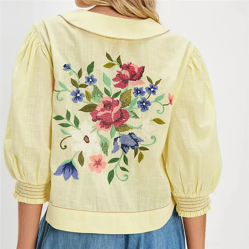Embroidered women's crop top by FJØRNA featuring intricate floral embroidery and a stylish, fitted design.