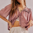 FJØRNA women's cotton blouse with ruffle detail, long sleeves, and elegant design, perfect for casual or dressy occasions.