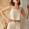 FJØRNA square neck linen cropped tank top displayed on a hanger, showcasing its stylish design and breathable fabric.