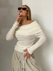 Off-shoulder ribbed knit top for women by FJØRNA, shown in a close-up image highlighting the textured fabric and stylish fit.