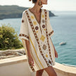 FJØRNA women's summer mini dress with floral print, V-neck, flowy design, perfect for beach and casual summer wear.