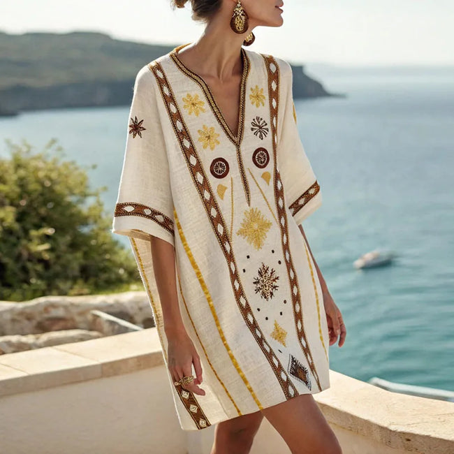 FJØRNA women's summer mini dress with floral print, V-neck, flowy design, perfect for beach and casual summer wear.