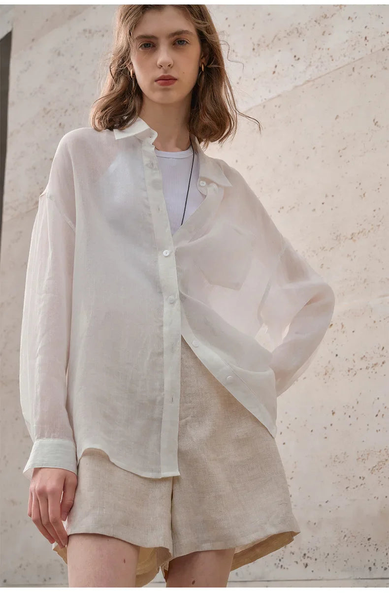 FJØRNA women's linen shirt, lightweight and breathable top, shown in a relaxed fit with long sleeves and natural linen fabric.