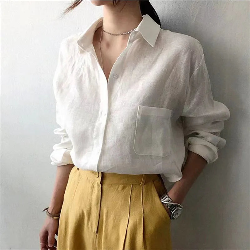 FJØRNA women's linen shirt with open collar, lightweight and breathable top, shown in a relaxed fit style in the image.