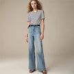 Women’s wide-leg cotton jeans by FJØRNA featuring high waist and relaxed fit, shown on a model in a casual outdoor setting.