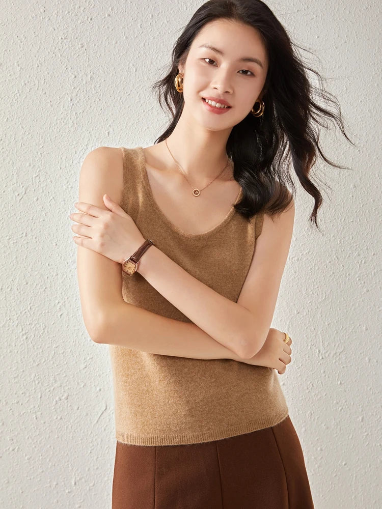 Soft beige FJØRNA women's cashmere top featuring a relaxed fit and ribbed neckline, perfect for cozy, stylish wear.