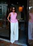 FJØRNA linen blend wide-leg high-waist women's trousers laid flat, showing neutral color and tailored fit.