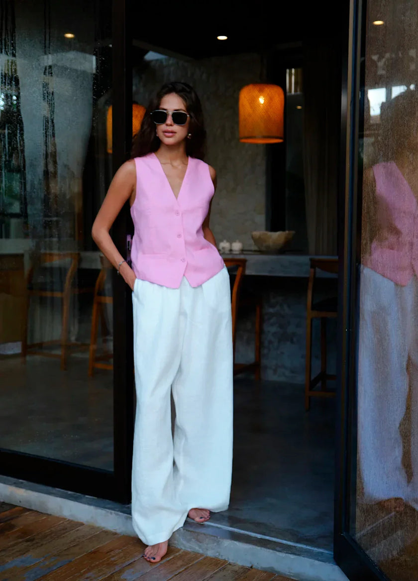 FJØRNA linen blend wide-leg high-waist women's trousers laid flat, showing neutral color and tailored fit.