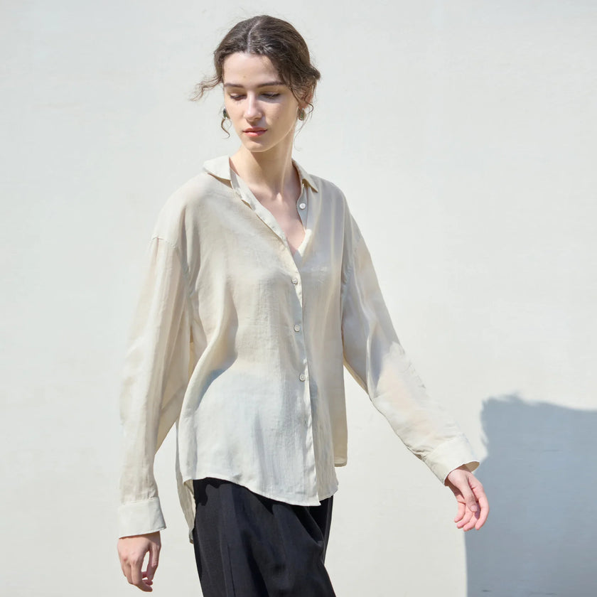 Women’s linen shirt by FJØRNA, casual and breathable top with long sleeves and a relaxed fit, shown in a neutral color.