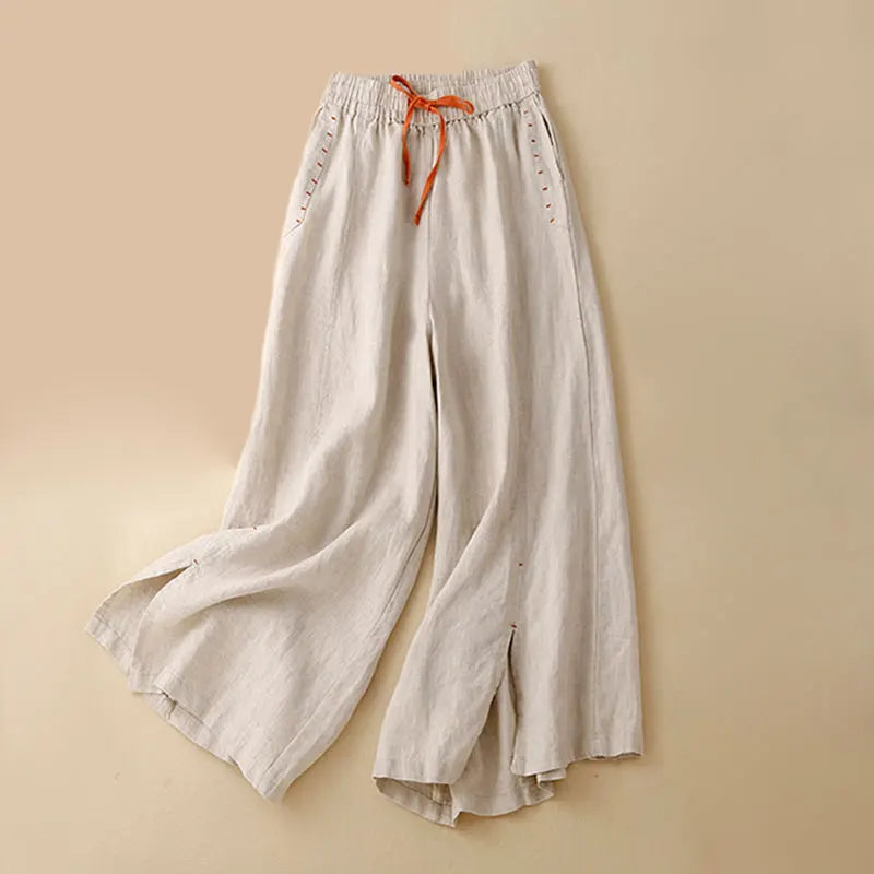 Women’s linen wide-leg trousers by FJØRNA with drawstring waist, relaxed fit, and lightweight breathable fabric.