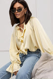 FJØRNA satin women's blouse with ruffle detail, elegant tops for women, showcasing soft fabric and stylish design.